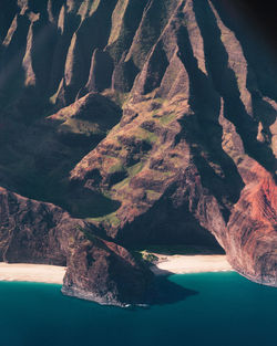 Shadow of person on rock by sea