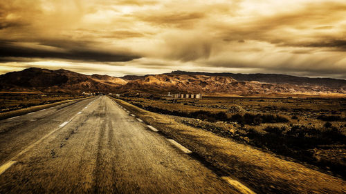 Road amidst landscape against sky