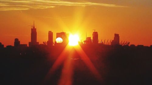 Sun shining through city