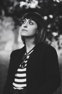 Portrait of young woman looking away outdoors