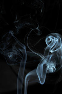 Close-up of cross against black background