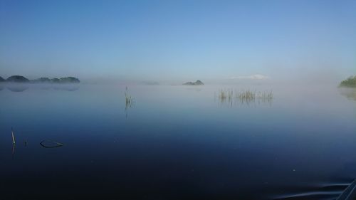 Scenic view of lake against blue sky