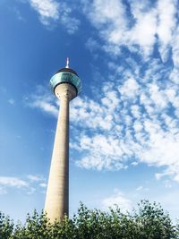 Low angle view of tower against cloudy sky