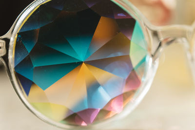 Close-up of multi colored glass on table