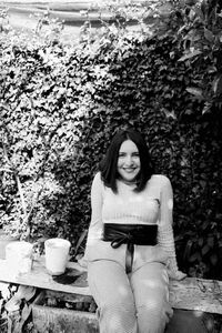 Portrait of a smiling young woman sitting outdoors