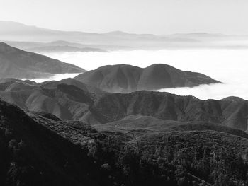 Scenic view of mountains against cloudy sky