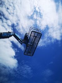 Low angle view of crane against sky