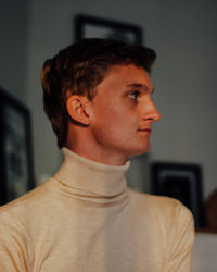 Portrait of young man looking away at home