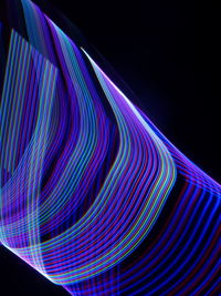 Light painting of multi colored lights over black background