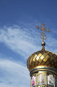 The golden dome of an orthodox village chapel against a blue sky. god. believers. vera. worship 