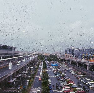 Cars on road in city against sky