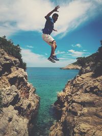 Woman jumping on rock