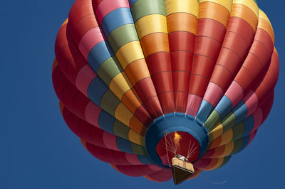 Low angle view of hot air balloon against blue sky