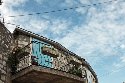 Low angle view of building against cloudy sky