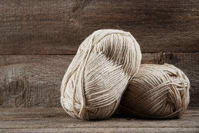 Two skeins of woolen yarn on wooden background