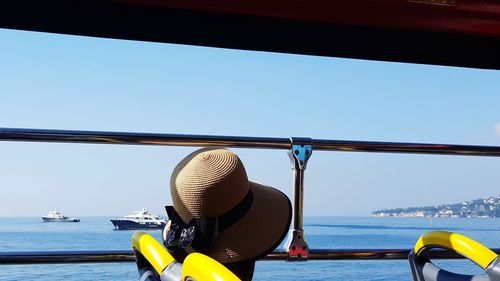 Nautical vessel on sea against clear blue sky