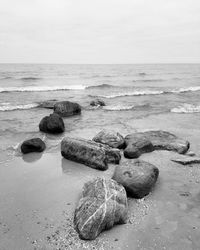 Rocks on beach against sky