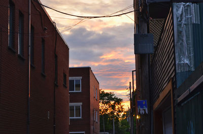 Low angle view of buildings against sky at sunset