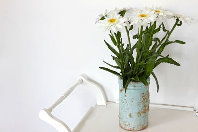 Close-up of white flower vase against wall at home