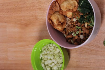 High angle view of chopped vegetables in bowl on table