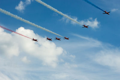 Low angle view of airplane flying against sky