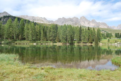 Scenic view of lake and mountains against sky