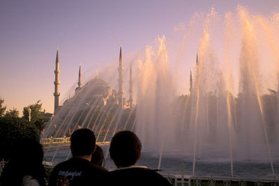 Rear view of people at fountain