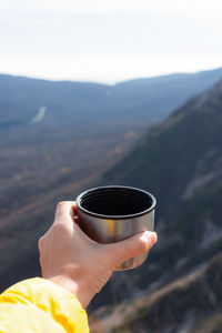 Cropped hand holding coffee