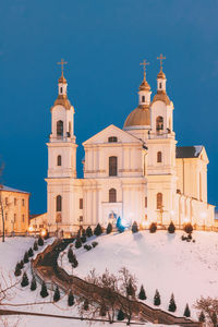 Historic building against blue sky during winter