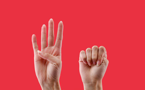 Close-up of human hand against green background