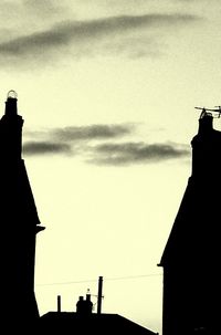 Low angle view of silhouette built structure against sky