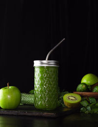 Close-up of apples on table against black background