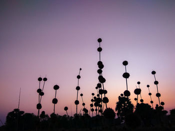 Low angle view of silhouette trees against sky at sunset