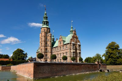 Low angle view of historic building against clear blue sky