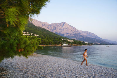 Full length of man on lake against sky