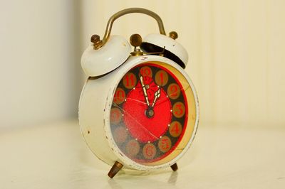 Close-up of old alarm clock on table