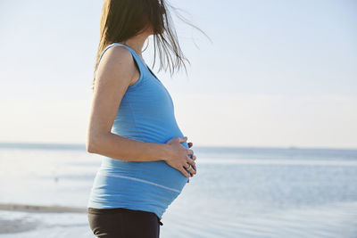 Pregnant woman at seaside