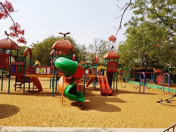 Playground in park against clear sky