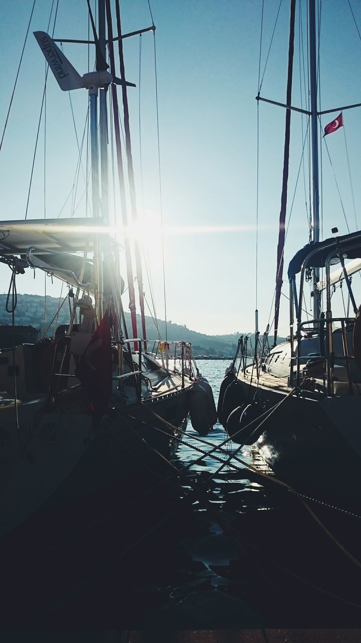 sunlight, sunbeam, sunny, transportation, harbor, clear sky, sky, day, sailboat, sun, water, lens flare, sea, city life, bright, diminishing perspective, marina, no people, vacations, dock