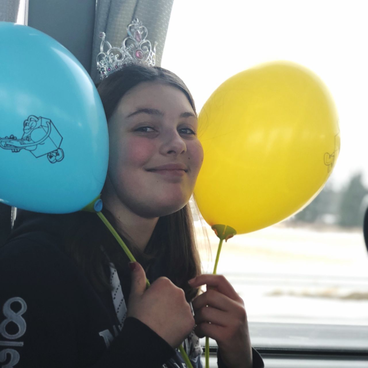 balloon, one person, real people, helium balloon, childhood, headshot, celebration, holding, portrait, looking at camera, birthday, front view, close-up, day, happiness, outdoors, bubble wand, young adult, people
