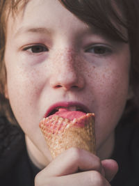 Close-up portrait of baby girl eating