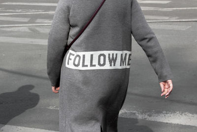 Low section of man standing on road