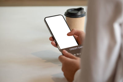 Midsection of person holding smart phone