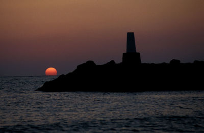 Scenic view of sea against clear sky during sunset