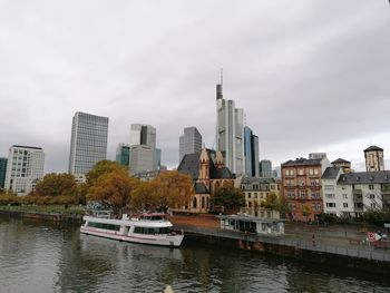 River by buildings against sky in city. frankfurt germany 