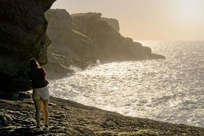 Rear view of man looking at sea shore