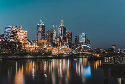 Reflection of illuminated buildings in city