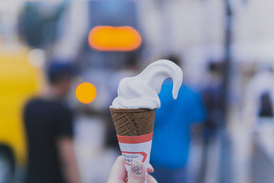 Close-up of hand holding ice cream cone