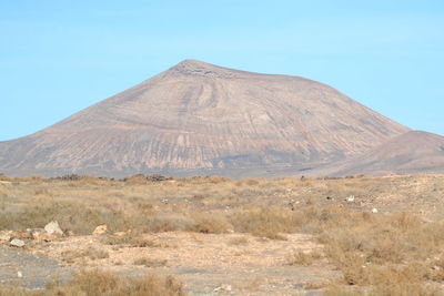 View of volcanic landscape against clear blue sky