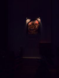 Portrait of man in illuminated room